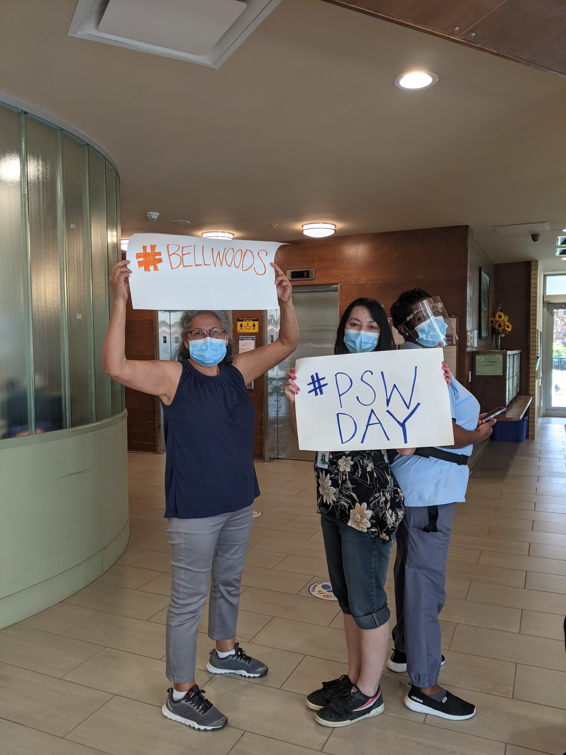 Bellwoods staff holding signs #Bellwoods and #PSW Day